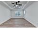 Bedroom with trey ceiling, fan, and wood-look floors at 4495 Hedgewood Dr, Cumming, GA 30041