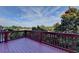 The wooden deck is perfect for enjoying the outdoors, with trees, blue skies and fair-weather clouds at 4495 Hedgewood Dr, Cumming, GA 30041