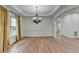 Spacious dining room with hardwood floors, detailed trim, and an elegant chandelier at 4495 Hedgewood Dr, Cumming, GA 30041