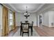 Elegant dining room with tray ceiling, crown molding, and modern chandelier at 4495 Hedgewood Dr, Cumming, GA 30041