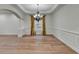 Elegant dining area featuring hardwood floors, classic wainscoting, and a decorative chandelier at 4495 Hedgewood Dr, Cumming, GA 30041