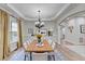 Elegant dining room with stylish chandelier, wainscoting and hardwood flooring at 4495 Hedgewood Dr, Cumming, GA 30041