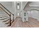 Open concept foyer with beautiful staircase and hardwood floors leading into the living space at 4495 Hedgewood Dr, Cumming, GA 30041