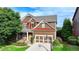 Beautiful two-story home featuring a well-maintained lawn, two-car garage, and charming front porch at 4495 Hedgewood Dr, Cumming, GA 30041