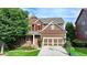 Beautiful two-story home featuring a well-maintained lawn, two-car garage, and charming front porch at 4495 Hedgewood Dr, Cumming, GA 30041