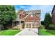 Beautiful two-story home featuring a well-maintained lawn, two-car garage, and charming front porch at 4495 Hedgewood Dr, Cumming, GA 30041