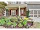 Landscaped front yard leading up to the stone-accented porch and red front door at 4495 Hedgewood Dr, Cumming, GA 30041