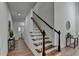 Bright hallway featuring hardwood floors, staircase, and decorative accents, creating a welcoming entrance at 4495 Hedgewood Dr, Cumming, GA 30041