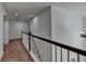 Bright hallway featuring hardwood floors and white railings at 4495 Hedgewood Dr, Cumming, GA 30041