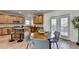 Open kitchen with an island and stainless steel appliances is situated adjacent to a breakfast area at 4495 Hedgewood Dr, Cumming, GA 30041