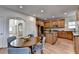 Open kitchen with wooden cabinets, granite countertops, stainless appliances, and eat-in dining area at 4495 Hedgewood Dr, Cumming, GA 30041