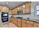 Spacious kitchen featuring wooden cabinets, granite countertops, stainless steel appliances, and a stylish backsplash at 4495 Hedgewood Dr, Cumming, GA 30041