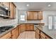 Modern kitchen with wood cabinets, granite counters, stainless steel appliances, and access to outdoors at 4495 Hedgewood Dr, Cumming, GA 30041