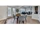 Cozy breakfast nook with hardwood floors, seamlessly connects to a bright living room with a stone fireplace at 4495 Hedgewood Dr, Cumming, GA 30041