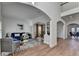 Open-concept living room with hardwood floors, white trim, and a view of the dining area at 4495 Hedgewood Dr, Cumming, GA 30041
