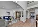 Open-concept living room with hardwood floors, white trim, and a view of the dining area at 4495 Hedgewood Dr, Cumming, GA 30041