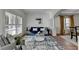 Bright living room with white plantation shutters, a blue sofa, and a modern glass coffee table at 4495 Hedgewood Dr, Cumming, GA 30041