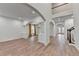 Open-concept living area featuring hardwood floors, arched doorways, and elegant columns at 4495 Hedgewood Dr, Cumming, GA 30041