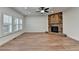 Cozy living room featuring a brick fireplace, recessed lighting, and plantation shutters at 4495 Hedgewood Dr, Cumming, GA 30041
