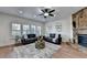 Bright living room with hardwood floors, a stone fireplace, ceiling fan, modern decor, and recessed lighting at 4495 Hedgewood Dr, Cumming, GA 30041