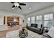 Bright and open-concept living space featuring hardwood floors, ceiling fan, open access to the kitchen and breakfast nook at 4495 Hedgewood Dr, Cumming, GA 30041