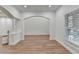 Open living space with hardwood floors, arched doorways, and crisp white walls at 4495 Hedgewood Dr, Cumming, GA 30041