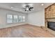 Well-lit living room with a brick fireplace, ceiling fan, and plantation shutters at 4495 Hedgewood Dr, Cumming, GA 30041