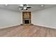 Comfortable living area with a brick fireplace, ceiling fan, and wood-look floors at 4495 Hedgewood Dr, Cumming, GA 30041