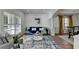 Bright living room with white plantation shutters, a blue sofa, and a modern glass coffee table at 4495 Hedgewood Dr, Cumming, GA 30041