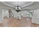 Inviting living area with hardwood floors, elegant wainscoting, and archway details at 4495 Hedgewood Dr, Cumming, GA 30041