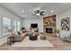 Comfortable living area with a brick fireplace, plush seating, and natural light at 4495 Hedgewood Dr, Cumming, GA 30041