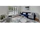 Cozy living room featuring a blue sofa, gray armchair, and a light blue area rug at 4495 Hedgewood Dr, Cumming, GA 30041