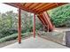 Covered patio with concrete flooring offers outdoor living space and access to the upper deck stairs at 4495 Hedgewood Dr, Cumming, GA 30041