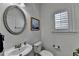 Well-lit powder room with modern fixtures, oval mirror, and window with shutters at 4495 Hedgewood Dr, Cumming, GA 30041