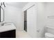 Well-lit bathroom featuring a modern vanity and open closet at 1105 Pine Heights Ne Dr, Atlanta, GA 30324