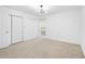 Bright bedroom featuring neutral carpeting, closet, and modern light fixture at 1105 Pine Heights Ne Dr, Atlanta, GA 30324