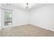 Bright bedroom featuring neutral carpeting, a window, and modern light fixture at 1105 Pine Heights Ne Dr, Atlanta, GA 30324