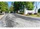 Community entrance featuring brick paved road, landscaping and decorative monument sign at 1105 Pine Heights Ne Dr, Atlanta, GA 30324