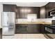 Modern kitchen with stainless steel appliances, dark cabinetry, and granite countertops at 1105 Pine Heights Ne Dr, Atlanta, GA 30324