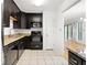 Well-equipped kitchen featuring granite counters, dark cabinets, and modern appliances at 1105 Pine Heights Ne Dr, Atlanta, GA 30324