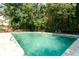 Large in-ground swimming pool with clear water and mature trees at 1105 Pine Heights Ne Dr, Atlanta, GA 30324