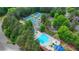 An aerial view of a community pool, clubhouse, and tennis courts surrounded by lush trees at 2530 Ashbourne Dr, Lawrenceville, GA 30043