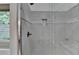 Beautiful tiled walk-in shower with glass door, built-in seat, and decorative niche for storage at 2530 Ashbourne Dr, Lawrenceville, GA 30043