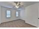 Bright bedroom with two windows, carpet flooring, and a ceiling fan at 2530 Ashbourne Dr, Lawrenceville, GA 30043