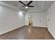 Spacious bedroom features a tray ceiling, modern ceiling fan, wood floors, and ensuite bathroom access at 2530 Ashbourne Dr, Lawrenceville, GA 30043