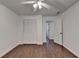 Bedroom with hardwood floors, closet, ceiling fan, and an open door at 2530 Ashbourne Dr, Lawrenceville, GA 30043