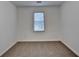 Small bedroom with neutral carpeting and window overlooking the back yard at 2530 Ashbourne Dr, Lawrenceville, GA 30043
