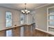 Open dining area with hardwood floors and view of front door at 2530 Ashbourne Dr, Lawrenceville, GA 30043