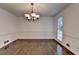Bright dining room featuring hardwood floors, white trim, and elegant chandelier at 2530 Ashbourne Dr, Lawrenceville, GA 30043