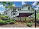 Back exterior view of house with white siding, deck, and patio at 2530 Ashbourne Dr, Lawrenceville, GA 30043